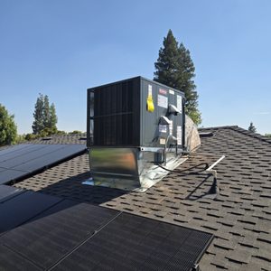 Rooftop HVAC unit installed alongside solar panels